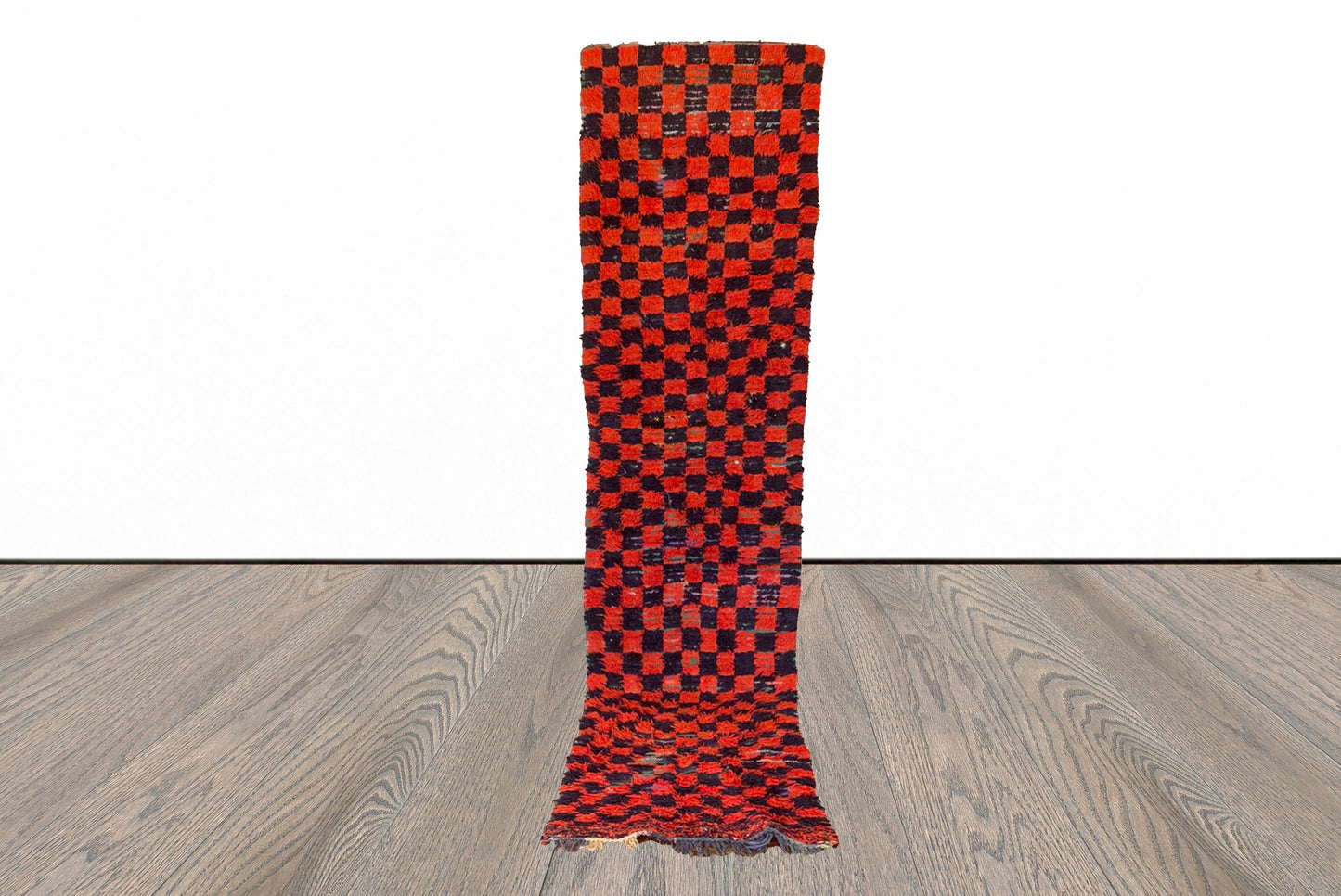 2x10 ft Moroccan red and black checkered runner rug.