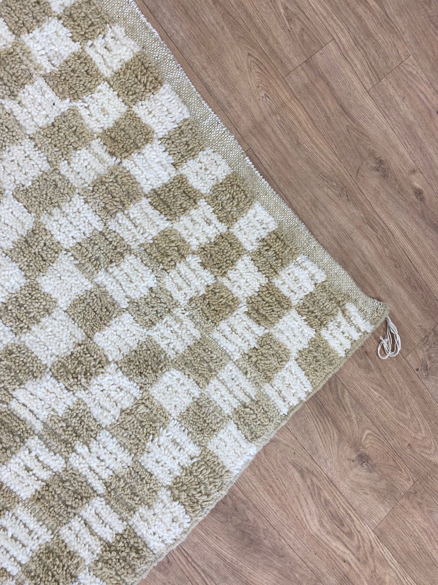 Checkered Beige and white area rug.